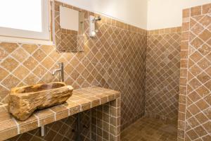 a bathroom with a stone sink on a counter at Royal Palm in Porto-Vecchio