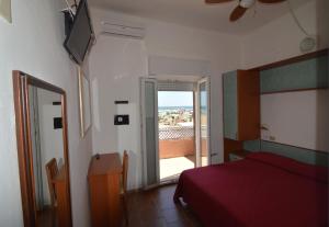 a bedroom with a bed and a view of the ocean at Hotel VistaMare Viserba in Rimini