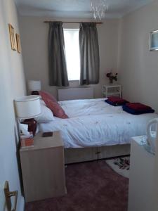 a bedroom with a large bed and a window at Sawbridgeworth Bed & Breakfast in Sawbridgeworth