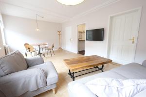 a living room with a couch and a table at Boutique Charme Apartments in Baden-Baden