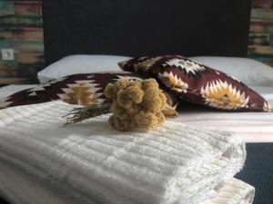a teddy bear sitting on top of a bed at Boho House in Pakoštane