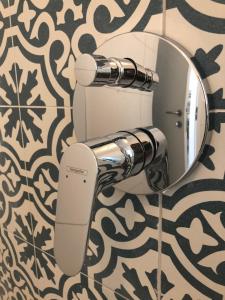 a bathroom with a toilet with a mirror on a wall at Boho House in Pakoštane