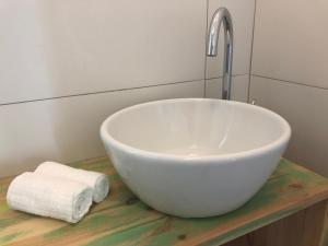 a bathroom with a white bowl sink and a faucet at Boho House in Pakoštane +21 photos