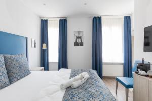 a hotel room with a bed with a towel on it at Residence Mutschellen in Zürich