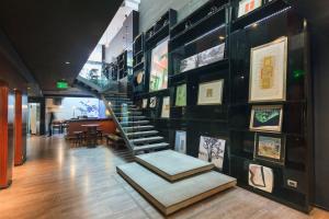 a staircase in a room with pictures on the wall at Hotel Ismael - Lastarria in Santiago +39 photos