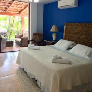 a bedroom with a bed with two towels on it at Hotel Boutique Villa Casuarinas in Cali
