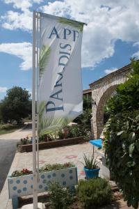 a white flag on a pole in a yard at Apartments Paradis in Rovinj