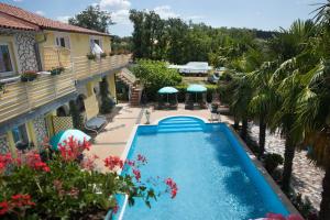 an overhead view of a swimming pool in front of a house at Apartments Paradis in Rovinj