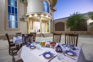 a table with blue and white dishes on it at Hotel "RAYHON" in Bukhara