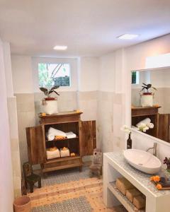 a bathroom with a sink and a mirror at Villa Jalun in Seminyak