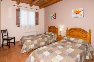 A bed or beds in a room at Ruralracons