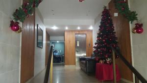 a christmas tree in a hallway with a person sitting in a chair at Copacabana Amazing Copacabana in Rio de Janeiro