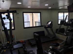 a gym with tread machines and a mirror at Flat Luxo Moema in Sao Paulo