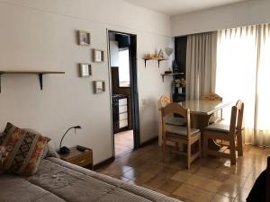 a living room with a table and a dining room at Ruffus's Apple Mardel in Mar del Plata