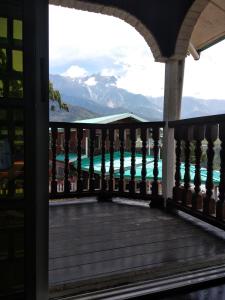 a balcony with a view of the mountains at Almeera Homestay 2 in Kundasang