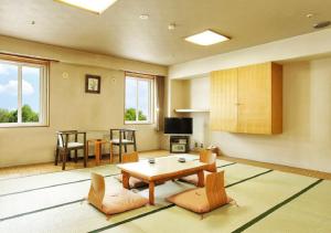 a large living room with a table and chairs at Hotel Niseko Alpen in Niseko
