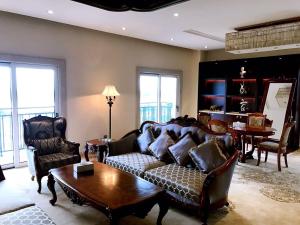 a living room with a couch and a table at Don Chan Palace Hotel & Convention in Vientiane