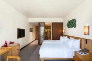 Ein Bett oder Betten in einem Zimmer der Unterkunft Dusit Princess Moonrise Beach Resort
