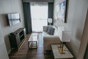 a living room with a couch and a tv at PVL Suites in Dumaguete
