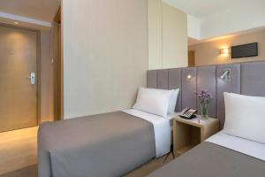 Postel nebo postele na pokoji v ubytování Silka Far East Hotel + 36 fotografií
