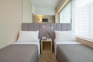 Postel nebo postele na pokoji v ubytování Silka Far East Hotel