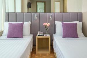 Postel nebo postele na pokoji v ubytování Silka Far East Hotel