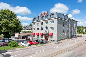 a building with a sign on it next to a parking lot at Best Western Sjofartshotellet in Oskarshamn