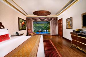 a bedroom with a bed and a living room at Mayfair Lagoon in Bhubaneshwar