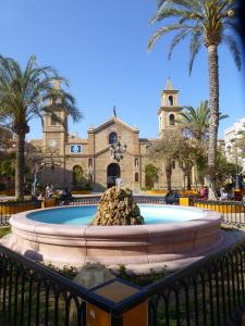 a fountain in front of a building with a church at Torrevieja - LaMata - Sonny in La Mata