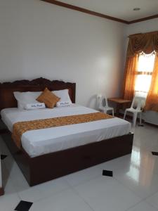 a bedroom with a large bed in a room at Andres Resort in Nabas