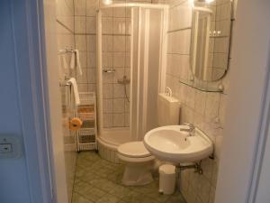 a bathroom with a sink and a toilet and a shower at Apartments Mija in Bol +51 photos