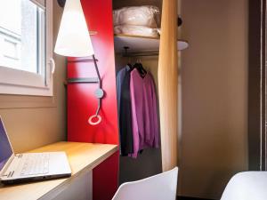 a room with a desk and a laptop and a lamp at ibis Bordeaux Centre - Gare Saint-Jean in Bordeaux