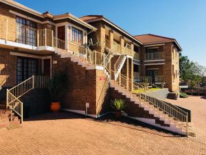 a brick building with stairs on the side of it at Country Link Guest Lodge in Komatipoort