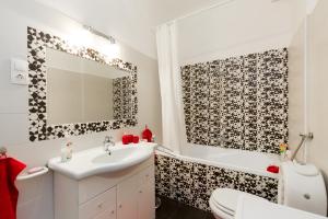 a bathroom with a sink and a toilet and a mirror at Rubinstein Relax Apartman in Budapest +16 photos