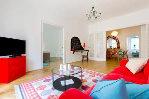 a living room with a red couch and a table at Rubinstein Relax Apartman in Budapest