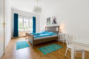 a bedroom with a bed and a table and chairs at Rubinstein Relax Apartman in Budapest