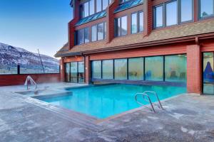 a house with a swimming pool in front of it at The Lodge at Mountain Village in Park City