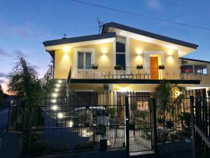 a white house with lights on the stairs at B & B Il Giardino sul Mare in Briatico