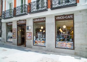 a store front with a variety of items on display at JC Rooms Chueca in Madrid