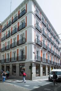 a white building with balconies on the side of it at JC Rooms Chueca in Madrid