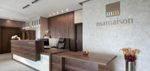 an office with a reception desk and amanagement sign on the wall at Mamaison Residence Sulekova Bratislava in Bratislava