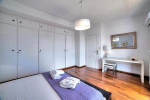 A bed or beds in a room at Athens Glyfada Riviera Apartment