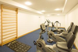 a gym with several exercise bikes in a room at Hotel Coronado in Mendrisio