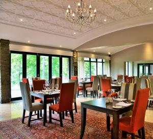a dining room filled with tables and chairs at Premier Resort Sani Pass in Himeville