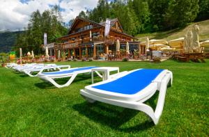 a row of beds on the grass in front of a building at Residence Campo Smith in Bardonecchia
