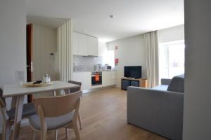 a kitchen and living room with a table and a couch at Spot Family Apartments in Porto