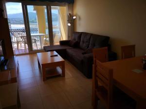 a living room with a couch and a table at Duplex Tres Dormitorios Playa A Rapadoira in Foz