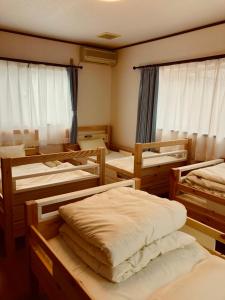 Postel nebo postele na pokoji v ubytování Fukunae House