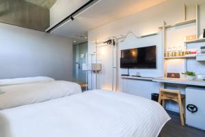 Ένα ή περισσότερα κρεβάτια σε δωμάτιο στο Hua Shan Din by Cosmos Creation - Huashan Creative Park