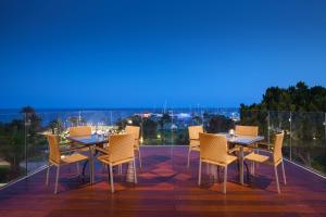 a table and chairs on a patio with a view at St Raphael Resort in Limassol